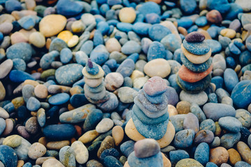 Close up of rocks stacked one on top of another with soft selective focus. Stones are naturally balanced on the background of the sea. High-quality free stock images of rocks and landscapes