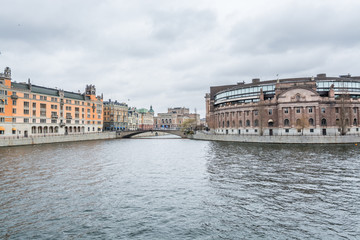 Fototapeta premium Riksdag (Parliament) Building at the bank of canal gainst cloudy sky in Stockholm, Sweden.