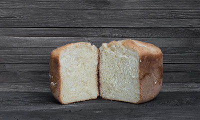 loaf of fresh hot white bread on a wooden rustic table