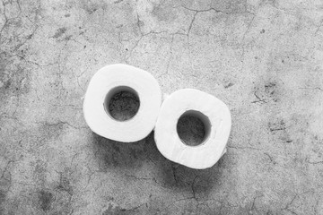 Toilet paper on the background of an article, banner or advertisement. Buying many rolls of toilet paper for fear of spreading coronavirus infection.