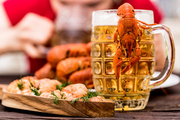 Boiled crayfish with beer on wooden background