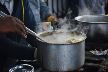 man making tea, on a street in nainital mall road, Indian Chai 