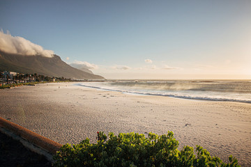 Evening golden light sunset in Camps Bay, Cape Town. Empty beach with no people.