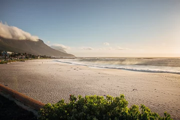Wall murals Camps Bay Beach, Cape Town, South Africa Evening golden light sunset in Camps Bay, Cape Town. Empty beach with no people.