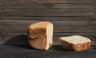 loaf of fresh hot white bread on a wooden rustic table