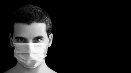 Headshot portrait of a white man with a facemask