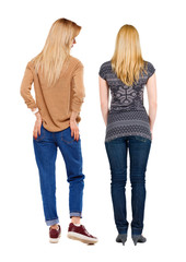 Back view of two woman in sweater.