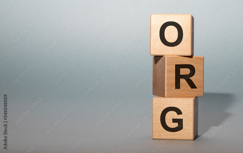Fototapete the word org written on cube blocks on grey blue background with copy space available