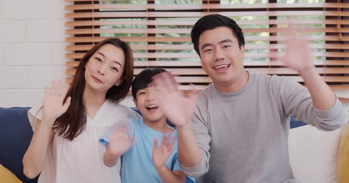Cheerful asian family looking to camera and talking at living room. They record video call together with happy emotion. Leisure, Lifestyle, Holidays and Family concept.