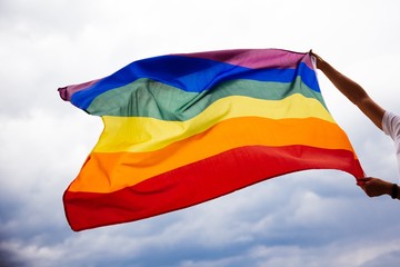 LGBT flag blown in the wind. Freedom and love concept. Pride month in June. 