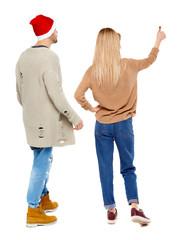Back view of couple in sweater showing thumbs up.