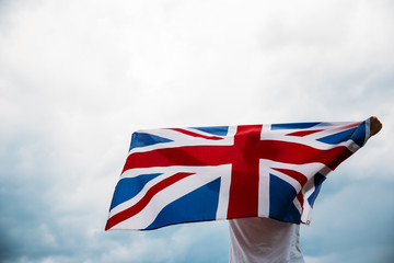 Man holding proudly the British flag. Patriot and supporter of Great Britain. 