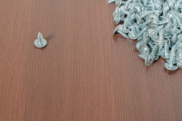 steel screws on a brown table