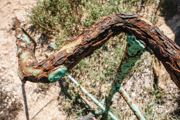 Rusty railing on the beach of the Black Sea. Iron construction gnawed iron cancer. Beautiful colorful collage.