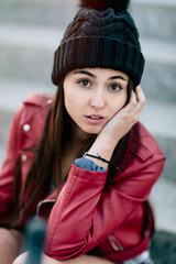 Portrait of a beautiful young hipster girl with red jacket