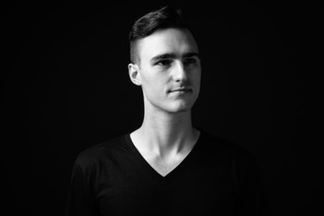 Face of young handsome man thinking and looking up