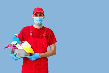 Cleaning man with a bucket and cleaning products on color background.