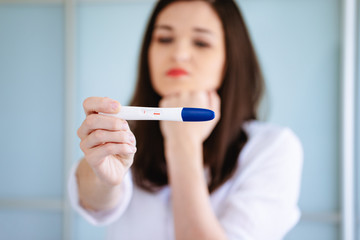 Young woman shocked to see a positive pregnancy test