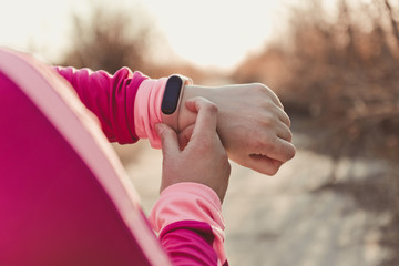 Healthy lifestyle concept of female hand with fitness bracelet tracker before jogging
