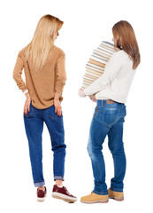 Back view of two woman in sweater.