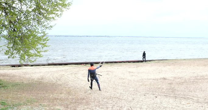 A man prepares a kite for skating