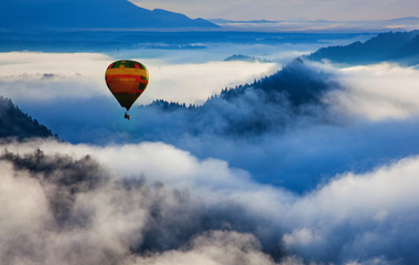 panorama of amazing foggy sunrise over mountains