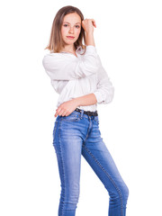 Obraz premium Portrait of a young beautiful blonde model in blue jeans and white shirt