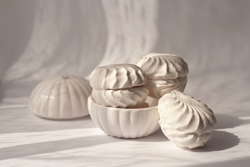 Meringue Marshmallow Zephyr with beautiful shadows. White sweet homemade zephyr or marshmallow....