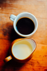 Top view Hot coffee and milk in white cup on the table in the morning