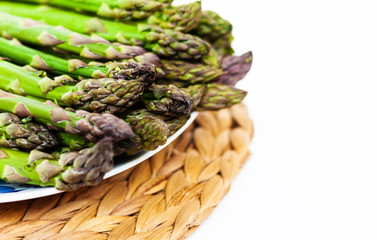 Bunch of fresh raw asparagus on white background, vegetarian concept. Green grass sparrowgrass sticks, food for veggie.