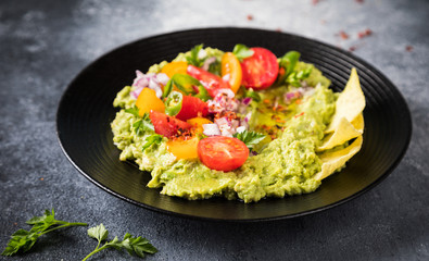Guacamole is a Traditional Mexican Sauce with Nachos.Vegetarian dish.