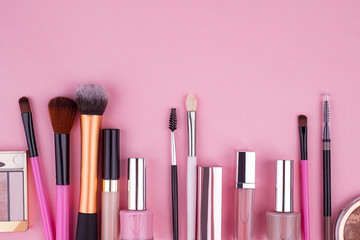 Decorative cosmetics, set of cosmetics on a pink background top view