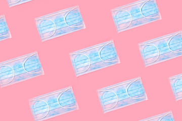 many blue masks on a pink background