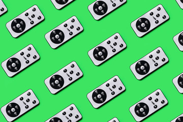 pattern of gray remotes on a green background