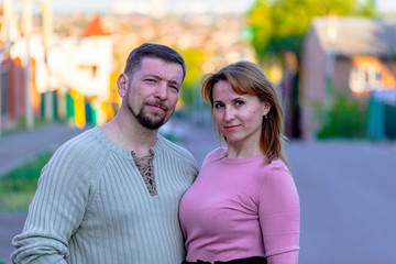 Obraz premium Happy married couple standing together on the street, tenderly holding hands.