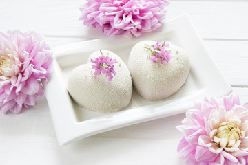 Heart  mousse cakes covered with white  chocolate velvet decorated of pink flowers