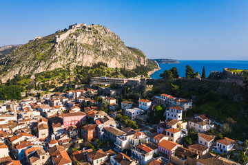 Old town of Nafplion in Greece view from above with tiled roofs, small port and bourtzi castle on...