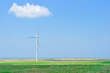 Fototapeta na wymiar wind generator on the field on a sunny day