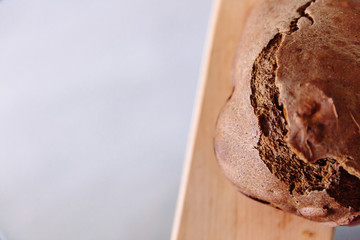 Fresh homemade crisp brown bread. Freshly baked bread on wooden cutting board. 