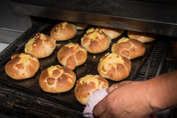 Traditional east european woman in authentic clothing kneading bread dough for 