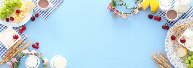 Top view photo of dairy products over pastel blue background. Symbols of jewish holiday - Shavuot