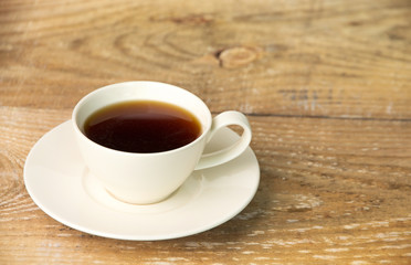Cup of coffee on wooden table