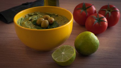 guacamole typical mexican food on wooden table
