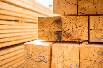 Stack of lumber wooden beams prepared to build a house
