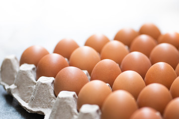 Pile of organic fresh and raw hen chicken eggs for sale in the tray market agriculture farm.High protein nutrition for healthy.Food,Business,Easter Concept.