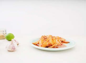 Raw chicken wings in Korean marinade. Cooking process.