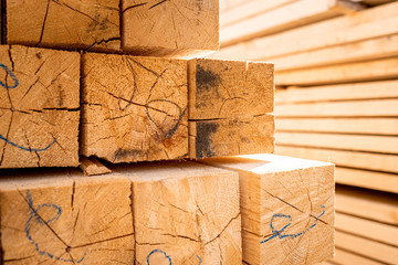 Stack of construction wood planks prepared for build a house