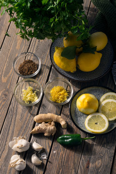 Summer ingredients, fresh green and yellow spices and flavours. Parsley, lemon, garlic, green chilli and ginger. Alternative medicine concept.