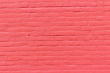 Old red painted brick wall texture background showing weathering from normal aging