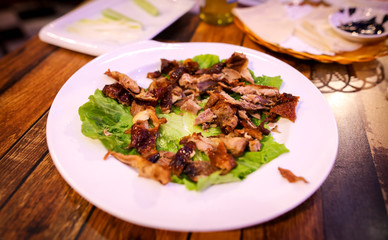 Peking duck in a plate on the table.